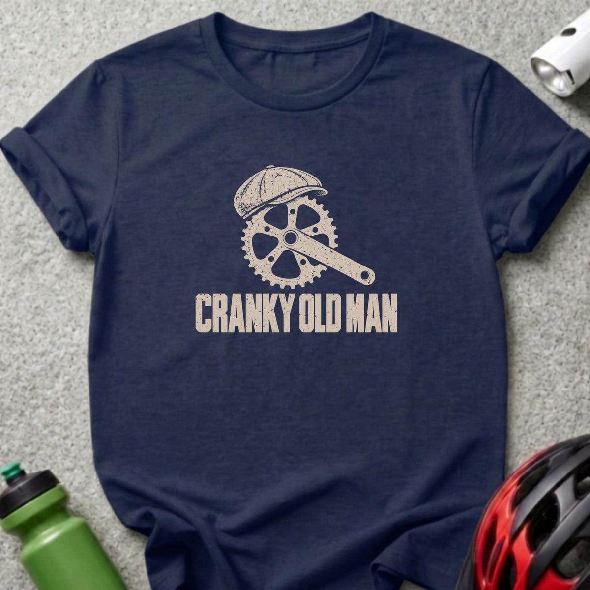 Dark blue t-shirt featuring a bicycle crank graphic wearing a flat cap and the text Cranky Old Man.