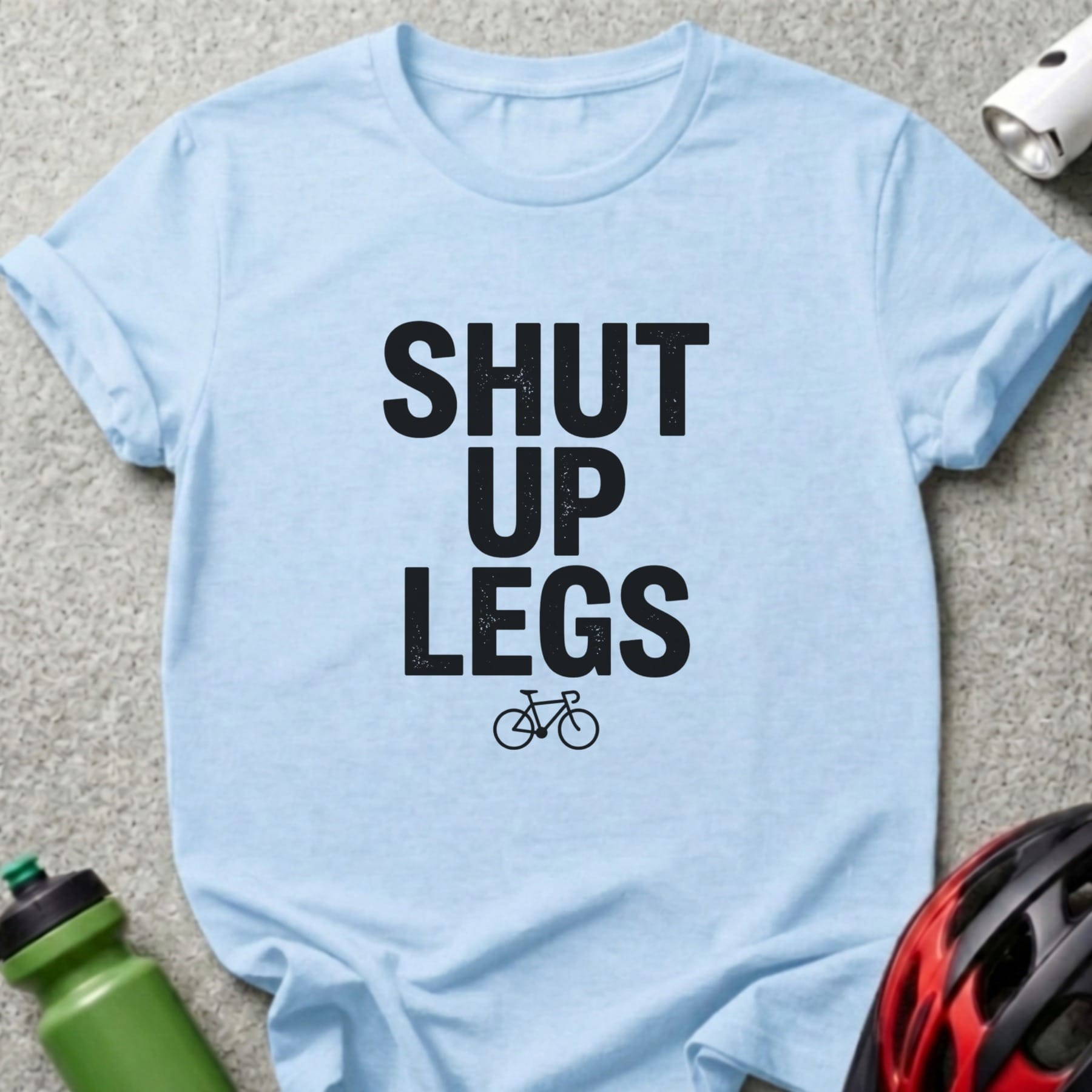 Light blue t-shirt with "SHUT UP LEGS" text and a bicycle graphic.