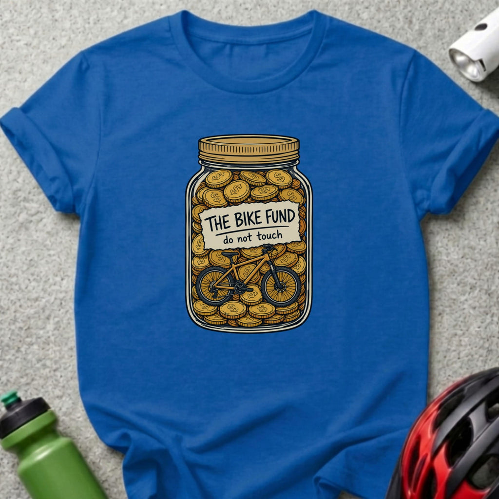 Blue t-shirt with a jar full of coins and a bicycle, reads "The Bike Fund".