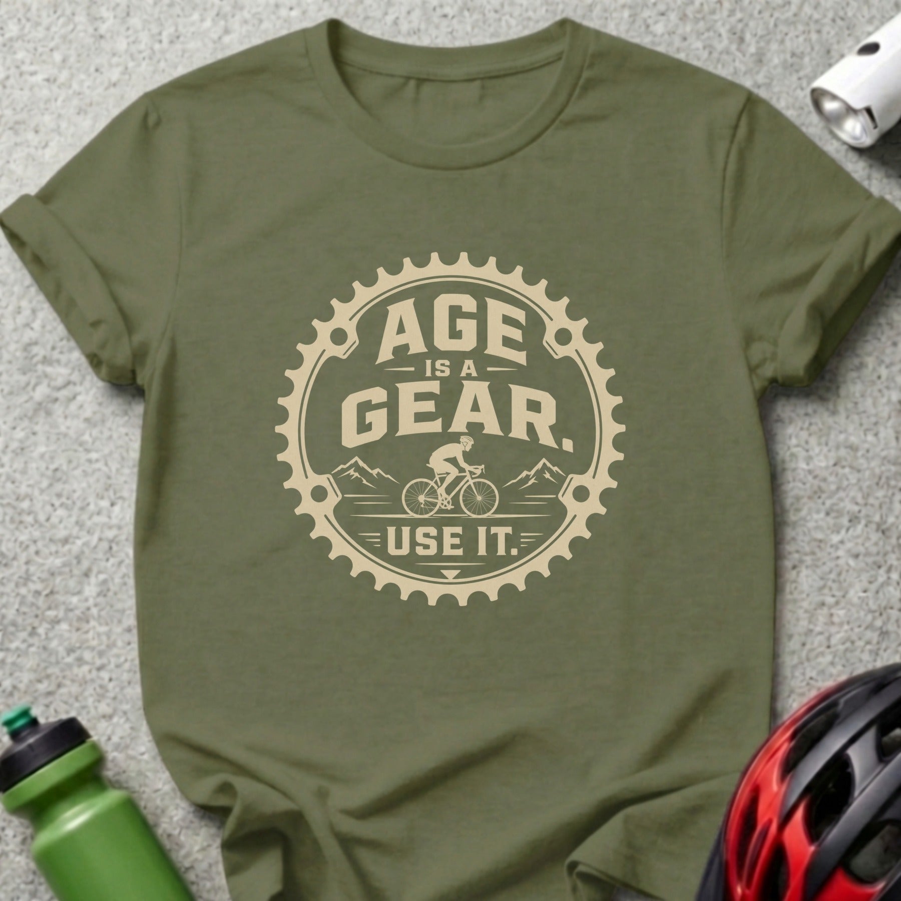 Olive t-shirt with "Age is a Gear. Use It." graphic inside a bicycle gear.