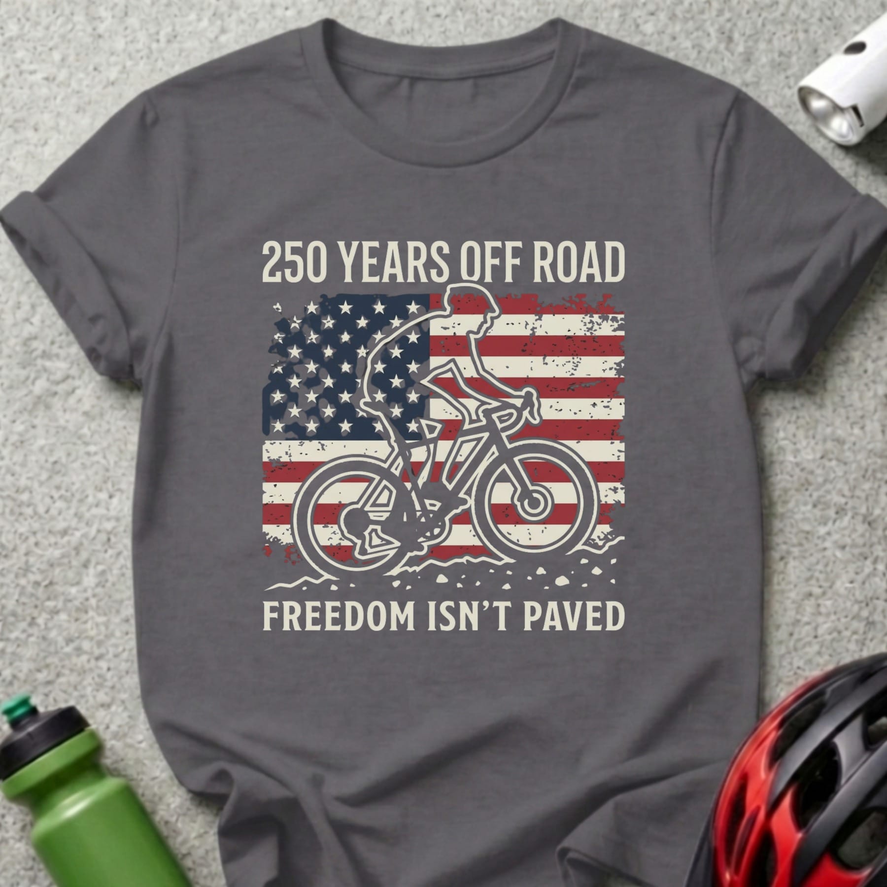 Cyclist silhouette on American flag, "250 Years Off Road Freedom Isn't Paved".