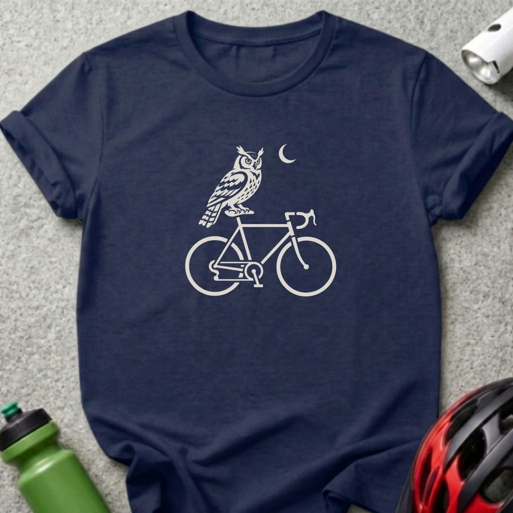 A navy blue t-shirt with a white graphic of an owl on a bicycle and a crescent moon.