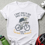 White t-shirt with skeleton on bicycle and text: "I don't ride to add days to my life, I ride to add beers to my afternoon."