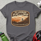 Dark grey t-shirt with mountain biking graphic that reads "It Looked Flat On The Map Somewhere in the Hill Country."