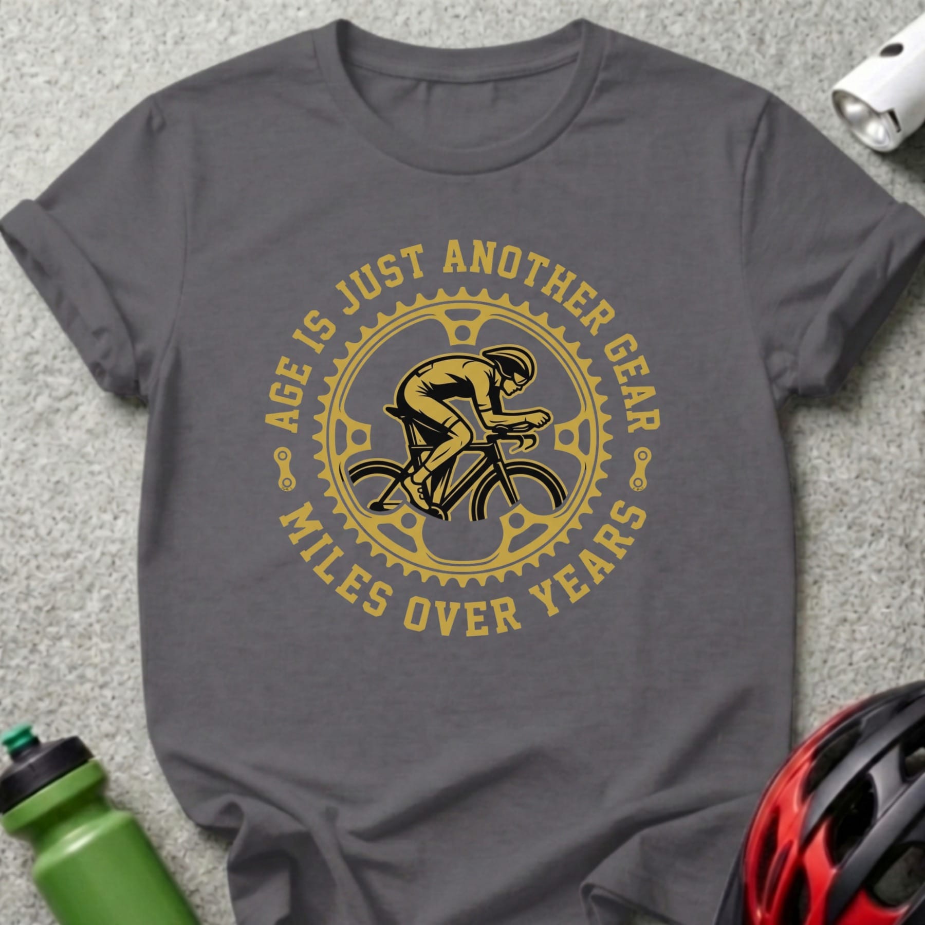 T-shirt with a cyclist and gears, reading "Age is just another gear, miles over years".