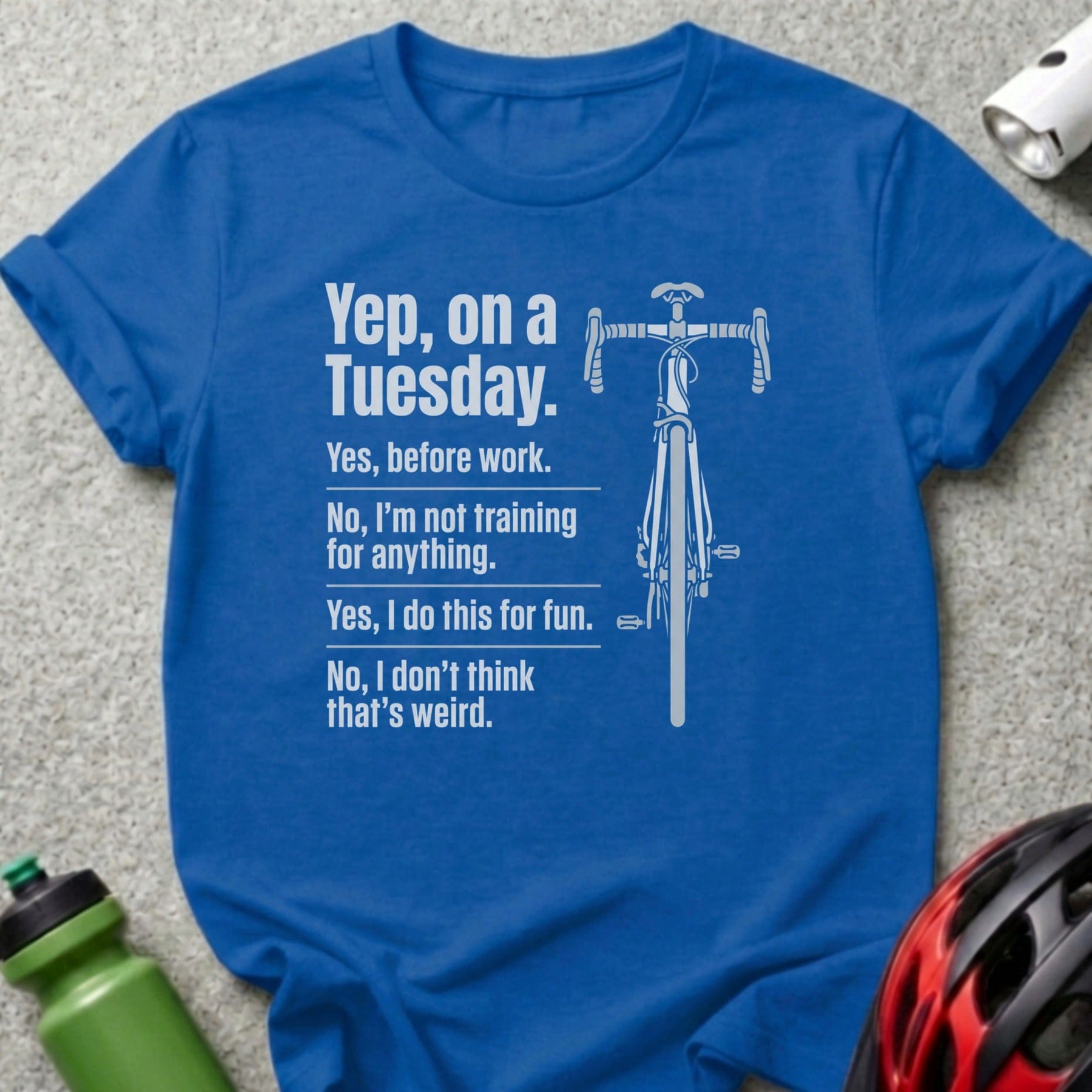 Blue t-shirt with white text and bicycle graphic about riding for fun.