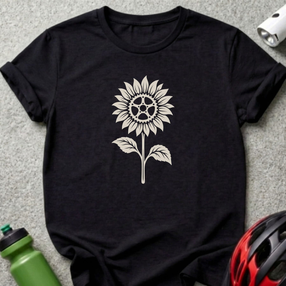 A black t-shirt printed with a beige graphic of a sunflower featuring a bicycle gear center.