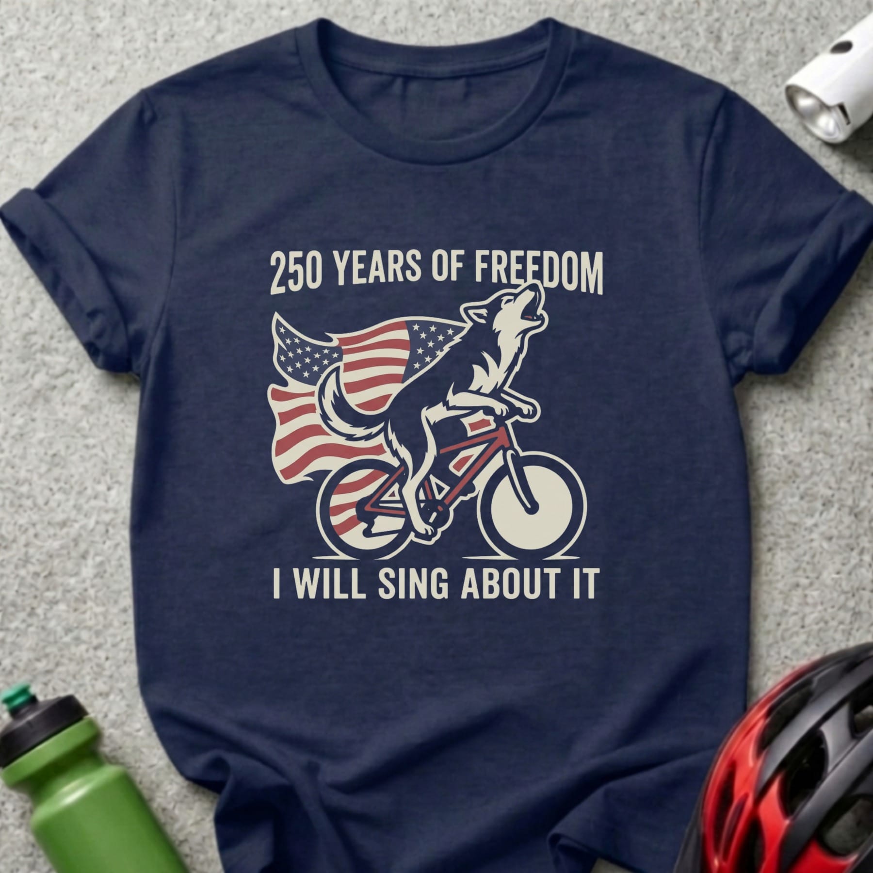 Wolf on bicycle with American flag, "250 Years of Freedom I Will Sing About It".