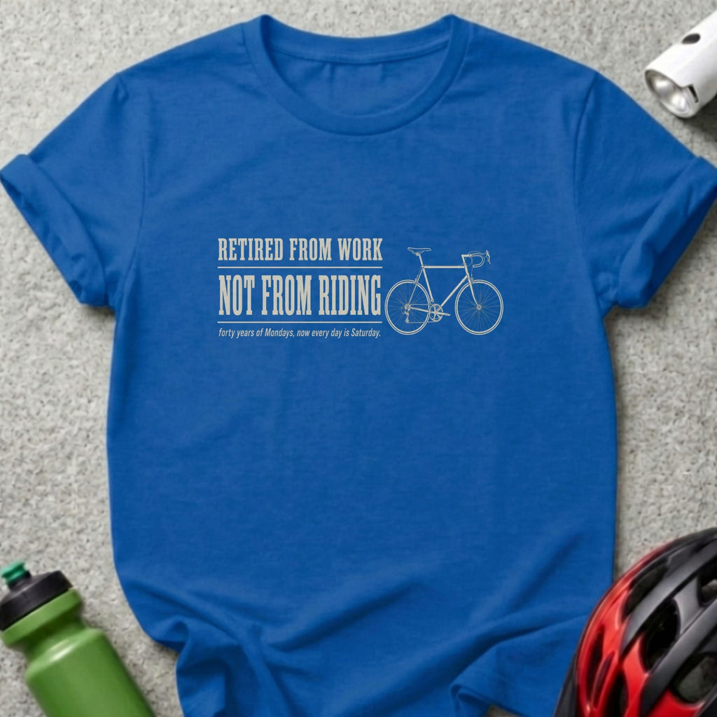 Blue t-shirt with text "Retired from work, not from riding" and bicycle graphic.