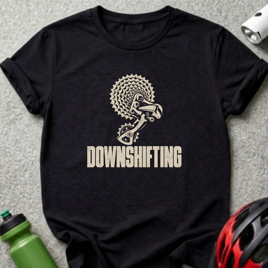 A black t-shirt features a white bicycle gear graphic and the word "DOWNSHIFTING".