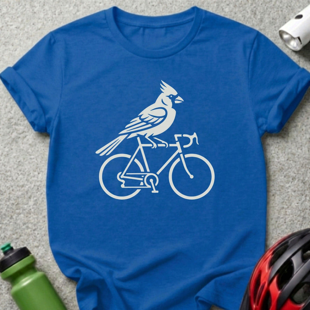 White cardinal riding a bicycle silhouette on a blue t-shirt.