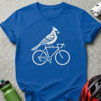 White cardinal riding a bicycle silhouette on a blue t-shirt.