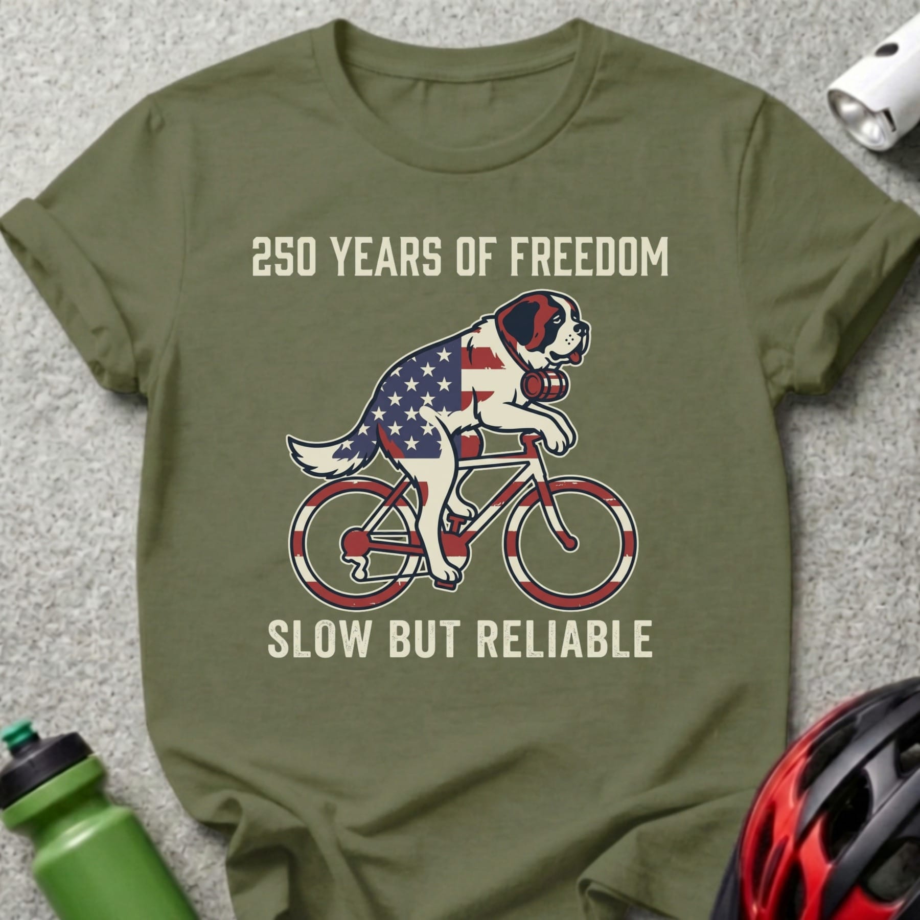 St. Bernard on bicycle, American flag pattern, text "250 Years of Freedom" and "Slow But Reliable".