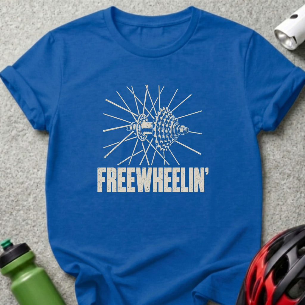 A blue t-shirt featuring a distressed white graphic of a bicycle wheel and the text FREEWHEELIN'.