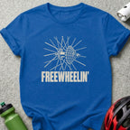 A blue t-shirt featuring a distressed white graphic of a bicycle wheel and the text FREEWHEELIN'.