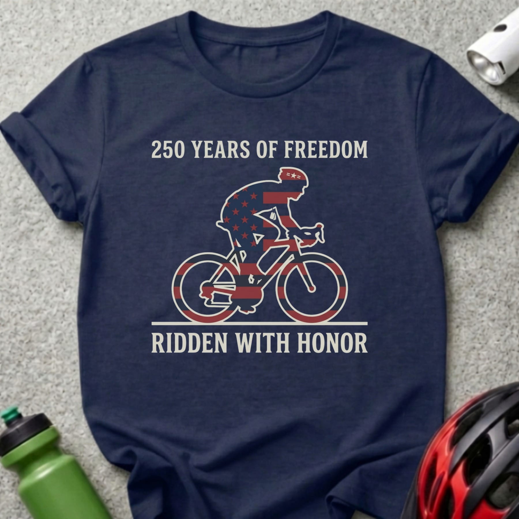 Navy t-shirt with cyclist silhouette, US flag design, and text "250 Years of Freedom Ridden With Honor".