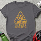 Dark grey t-shirt with yellow graphic: "CAUTION: CRANKY BEFORE COFFEE"