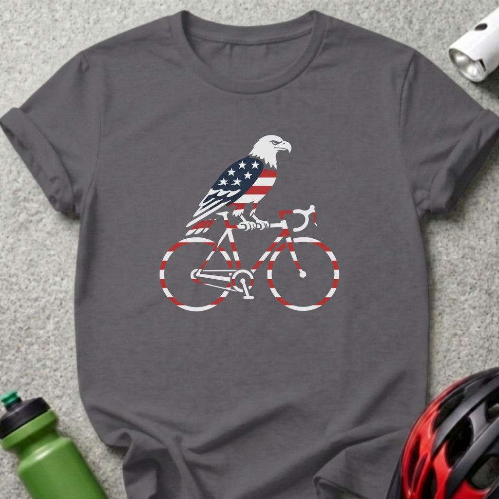Eagle with American flag on bicycle graphic on dark gray t-shirt.