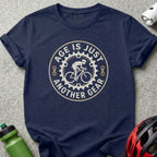 Navy t-shirt with "Age is just another gear" cyclist graphic.