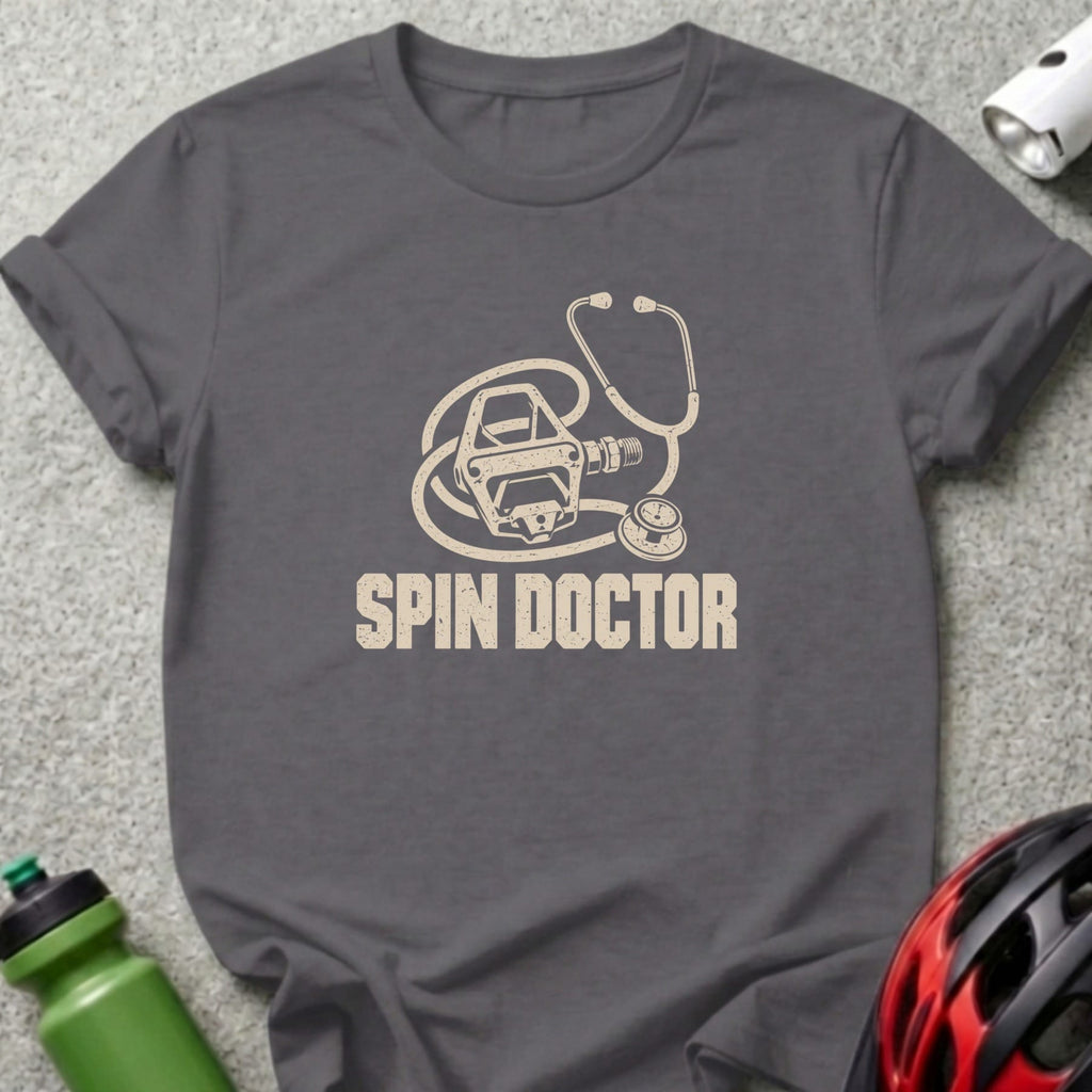 Dark gray t-shirt with a graphic of a bicycle pedal shaped like a stethoscope and text reading Spin Doctor.