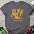 Gray t-shirt with text "SLOW CYCLING CLUB" and "No rush. Just Vibes."