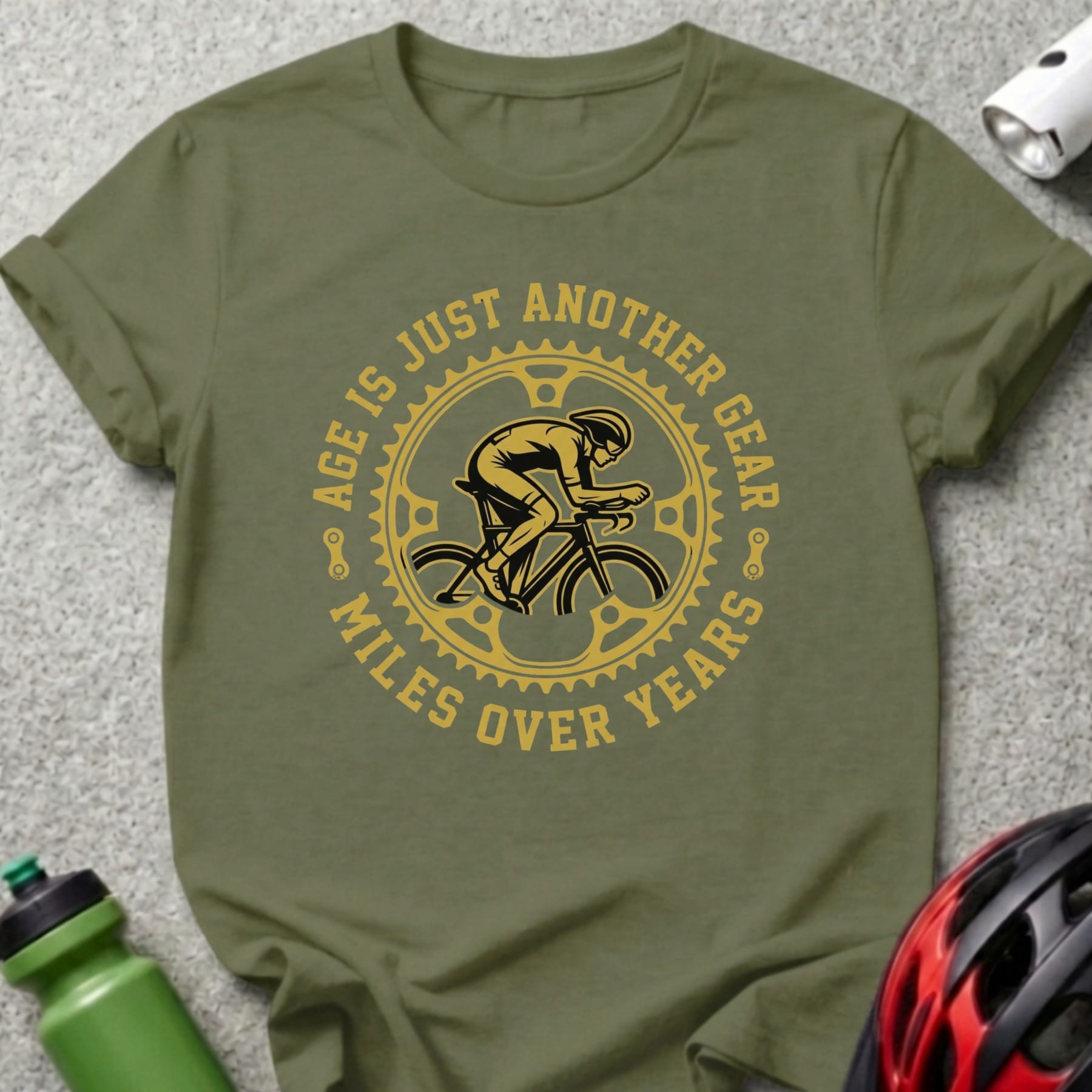 Cyclist graphic with text "Age is just another gear, miles over years" on a green t-shirt.
