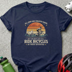 Dark blue t-shirt with graphic: "All men are created equal but the best can still ride bicycles in their seventies."