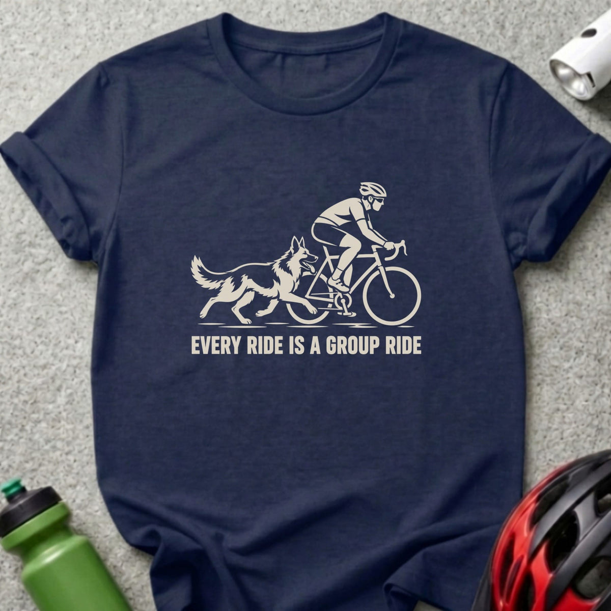 A dark blue t-shirt with a white graphic of a cyclist and dog, featuring the text "EVERY RIDE IS A GROUP RIDE".