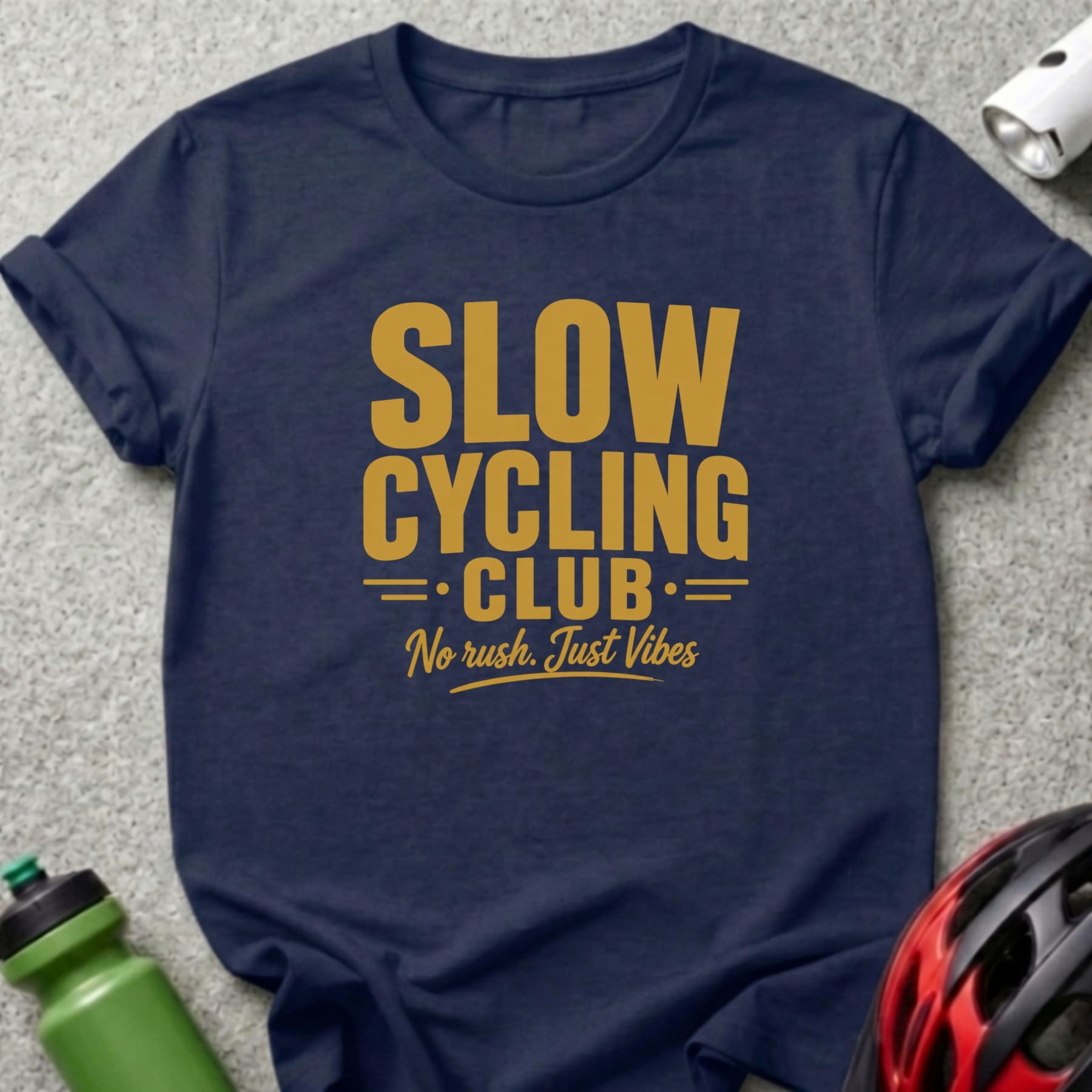 Navy t-shirt with gold text "SLOW CYCLING CLUB. No rush. Just Vibes."