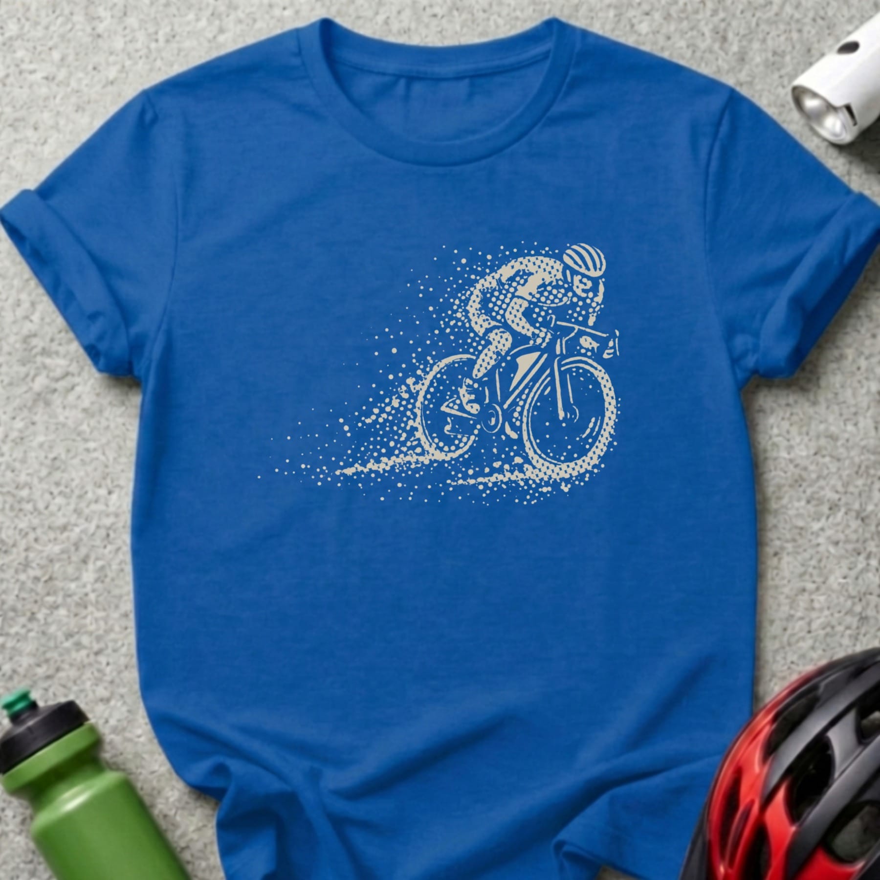 Blue t-shirt with cyclist illustration breaking through a spray of dust.