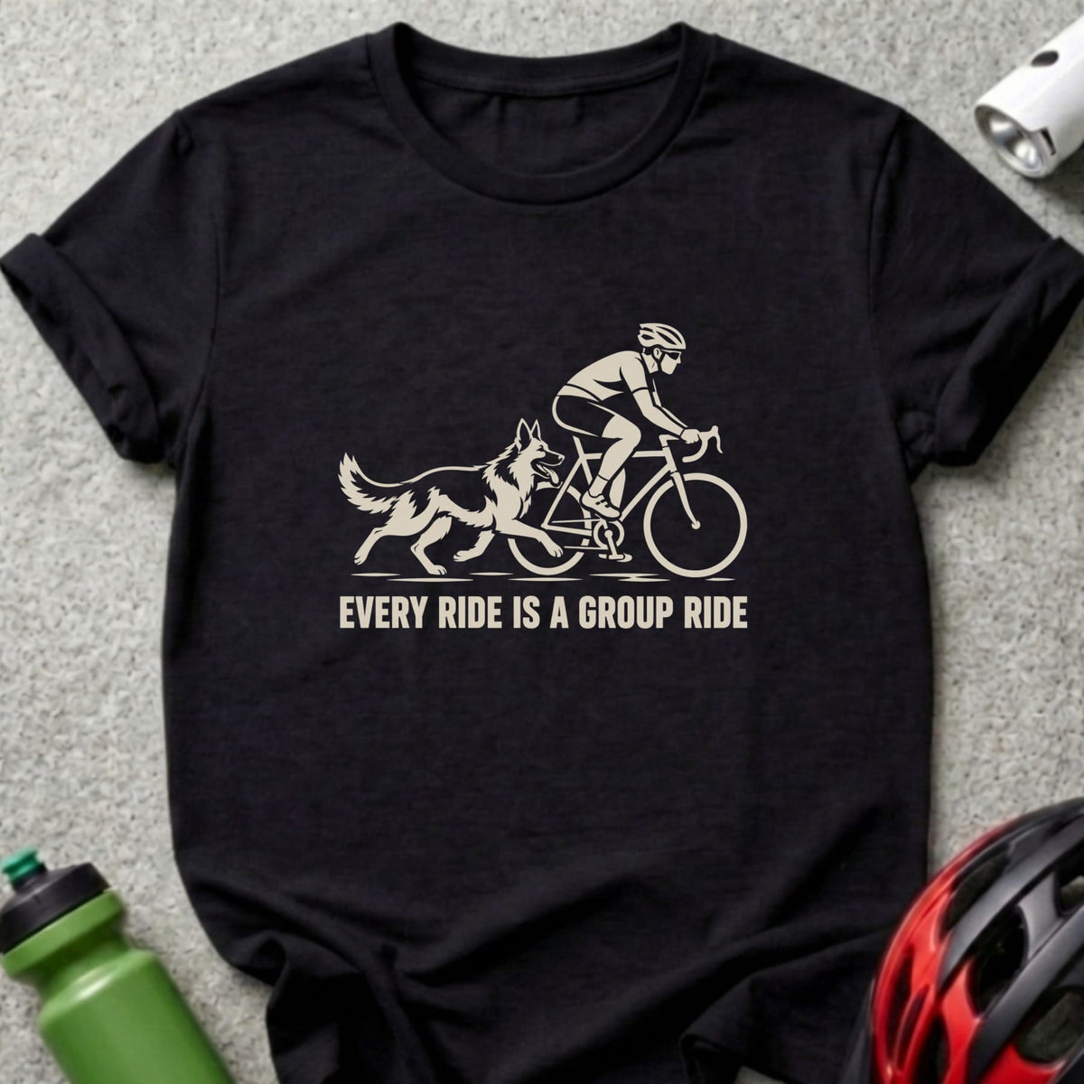 A black crew neck t-shirt featuring a graphic of a cyclist riding with a dog and the text every ride is a group ride.