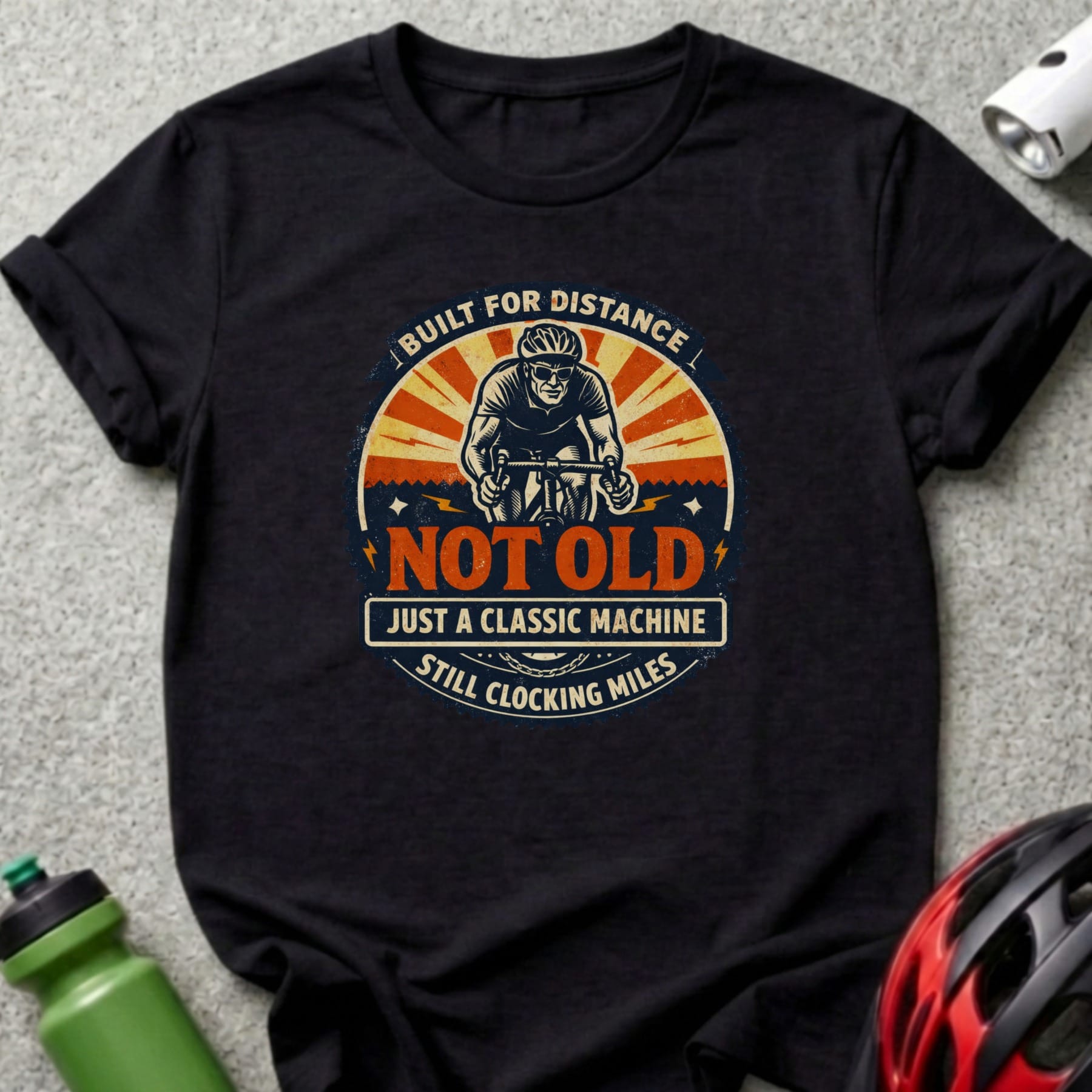 Black t-shirt with cyclist graphic and text "NOT OLD JUST A CLASSIC MACHINE STILL CLOCKING MILES".