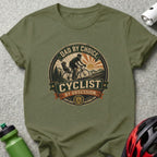 Dad by Choice Cyclist by Obsession graphic tee with bicycle and mountain scene.