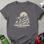 Charcoal t-shirt featuring a graphic of a cyclist climbing a mountain road with the text CLIMB EVERY MOUNTAIN, EVENTUALLY.