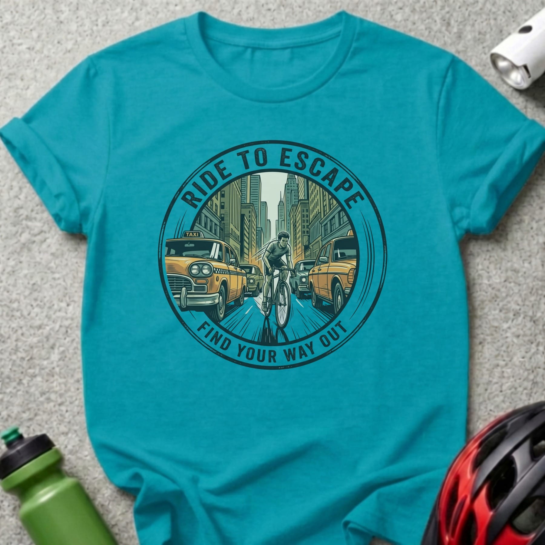 Turquoise t-shirt with circular graphic of cyclist escaping traffic, "Ride to Escape" and "Find Your Way Out".