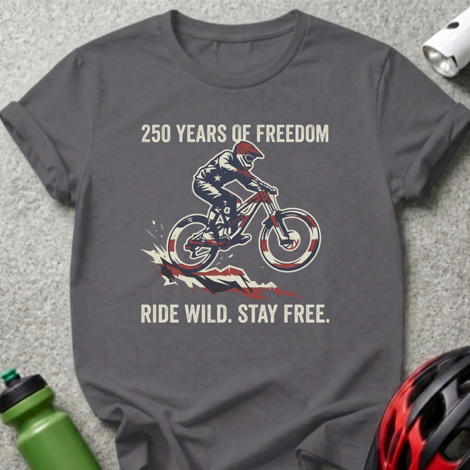 Dark grey t-shirt with "250 Years of Freedom Ride Wild. Stay Free." text and cyclist graphic.