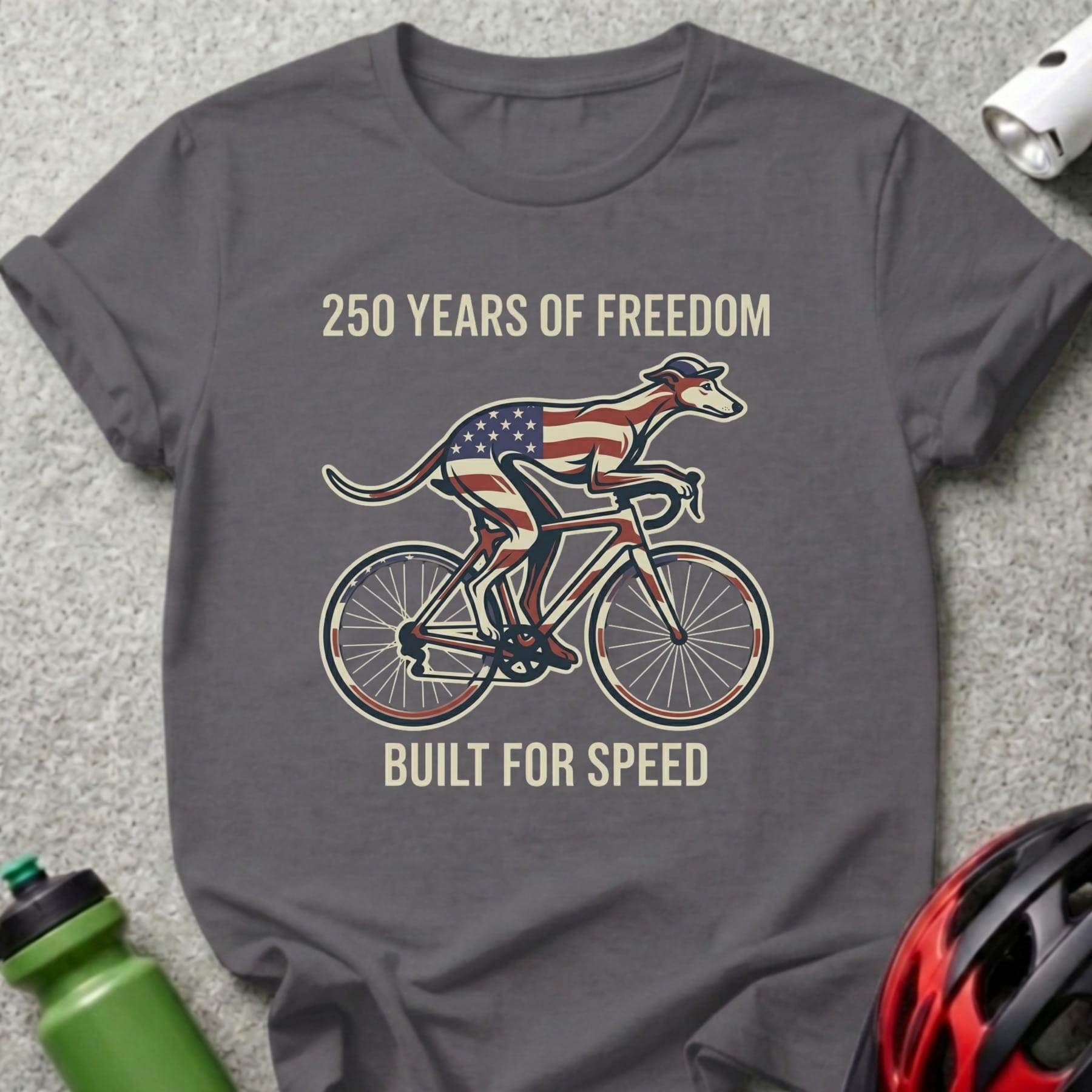 Grey t-shirt with a greyhound on a bicycle, American flag design, and text.