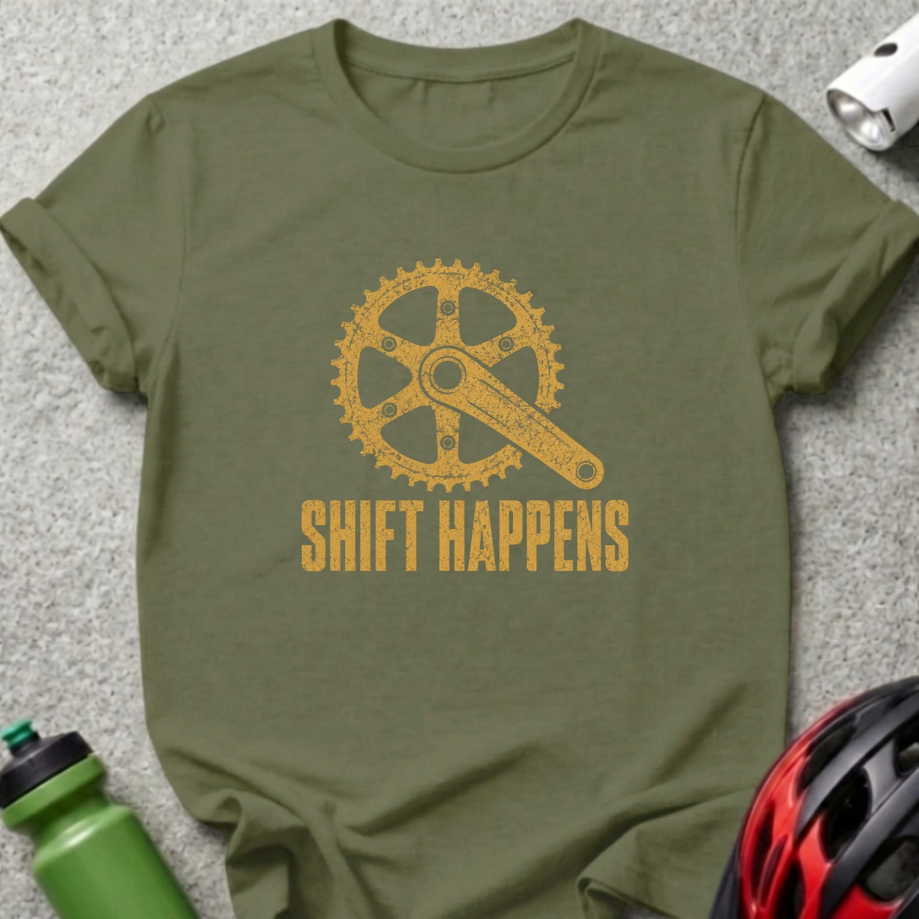 Olive green t-shirt with yellow bicycle gear graphic and text "SHIFT HAPPENS".