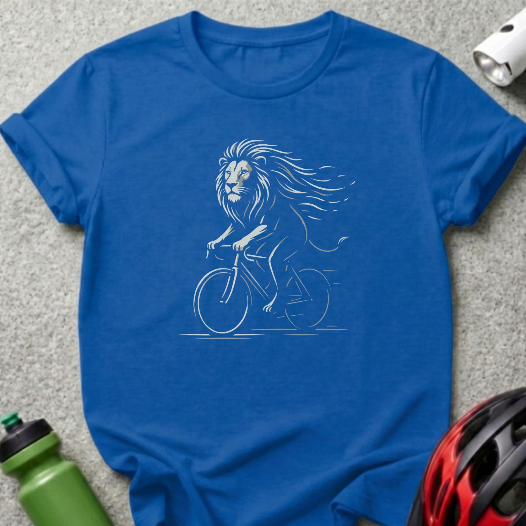 Blue t-shirt with a white line drawing of a lion riding a bicycle.