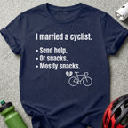 Navy t-shirt with text "I married a cyclist. Send help. Or snacks. Mostly snacks." and bicycle graphic.