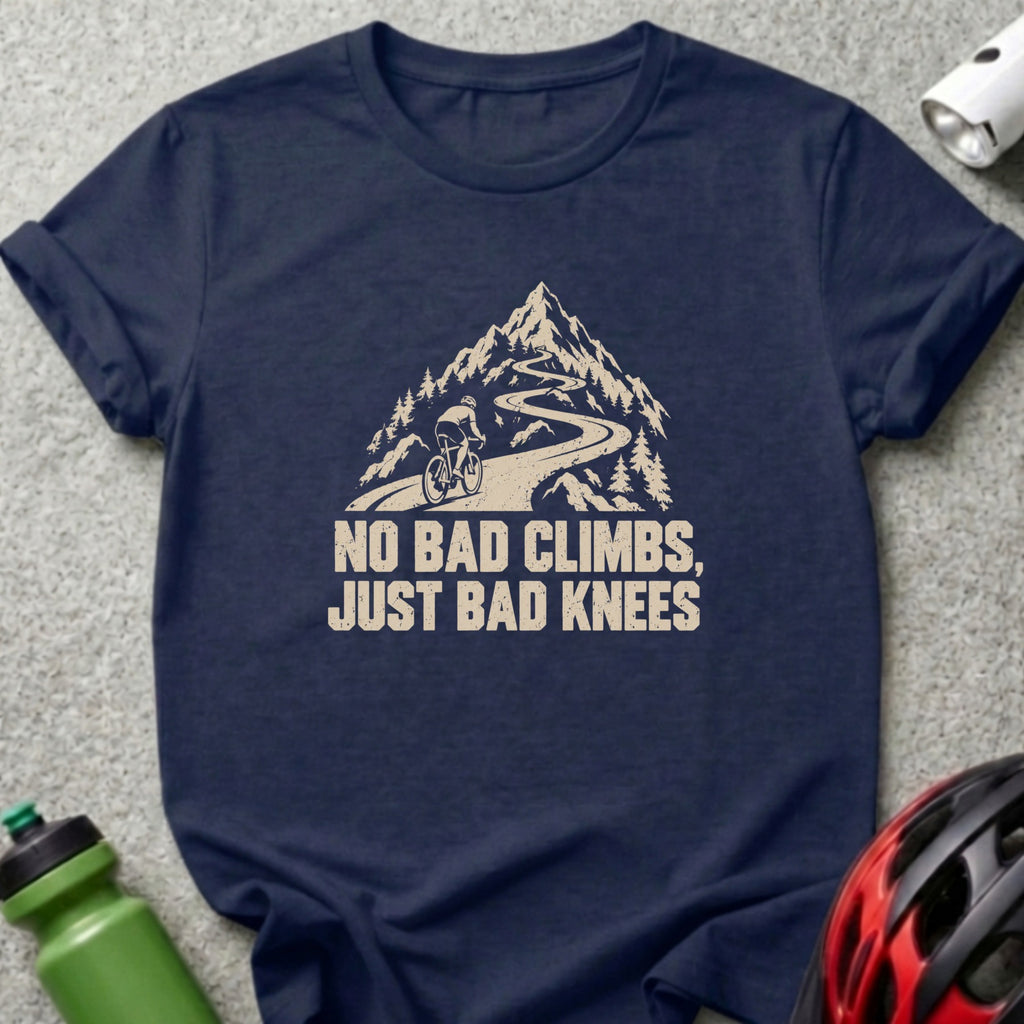 Navy blue crewneck t-shirt featuring a graphic of a cyclist climbing a mountain road with the text "NO BAD CLIMBS, JUST BAD KNEES".