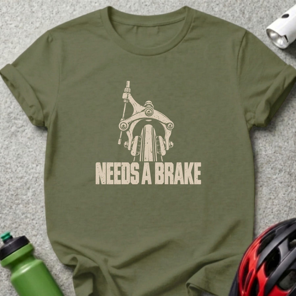 An olive green t-shirt with a vintage graphic of a bicycle brake and the text NEEDS A BRAKE.