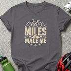 Grey t-shirt with "Miles Made Me" text and bicycle graphic.