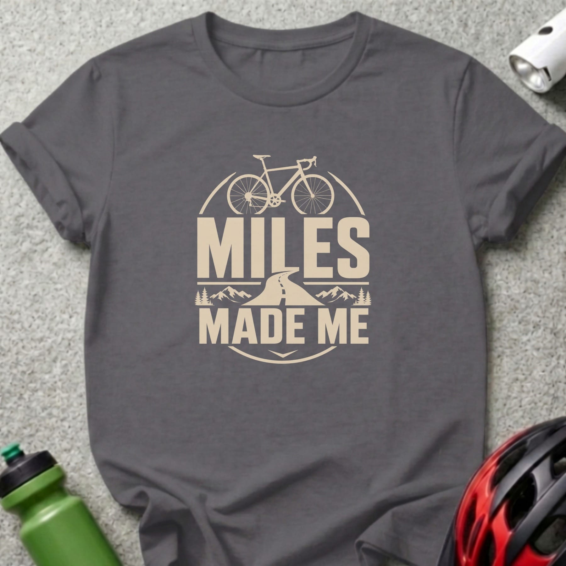 Grey t-shirt with "Miles Made Me" text and bicycle graphic.