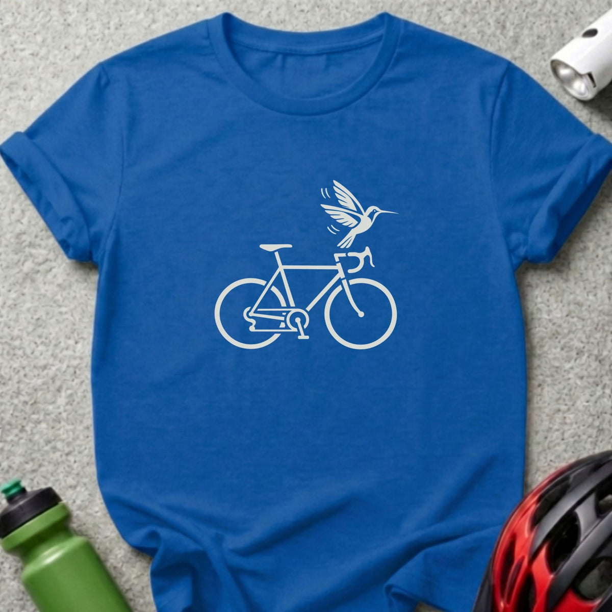 A blue crewneck t-shirt featuring a white graphic of a bicycle with a hummingbird flying above it.