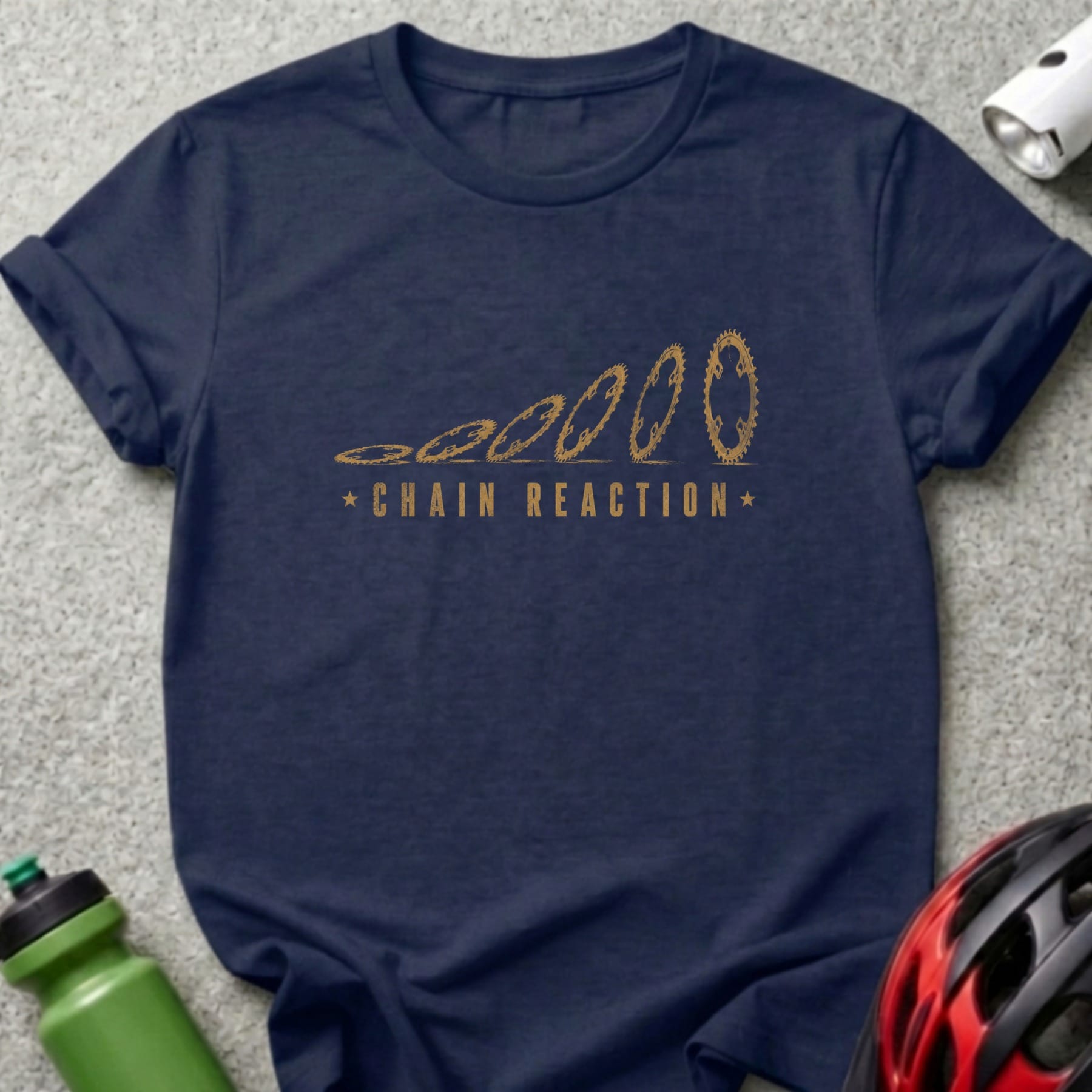 Navy t-shirt with gold chainring graphic and "CHAIN REACTION" text.