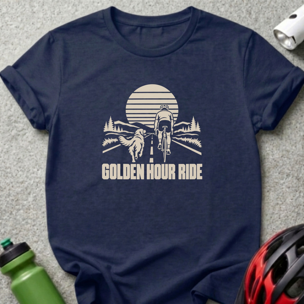 A navy blue t-shirt with a graphic of a cyclist and dog on a road, featuring the text "GOLDEN HOUR RIDE".