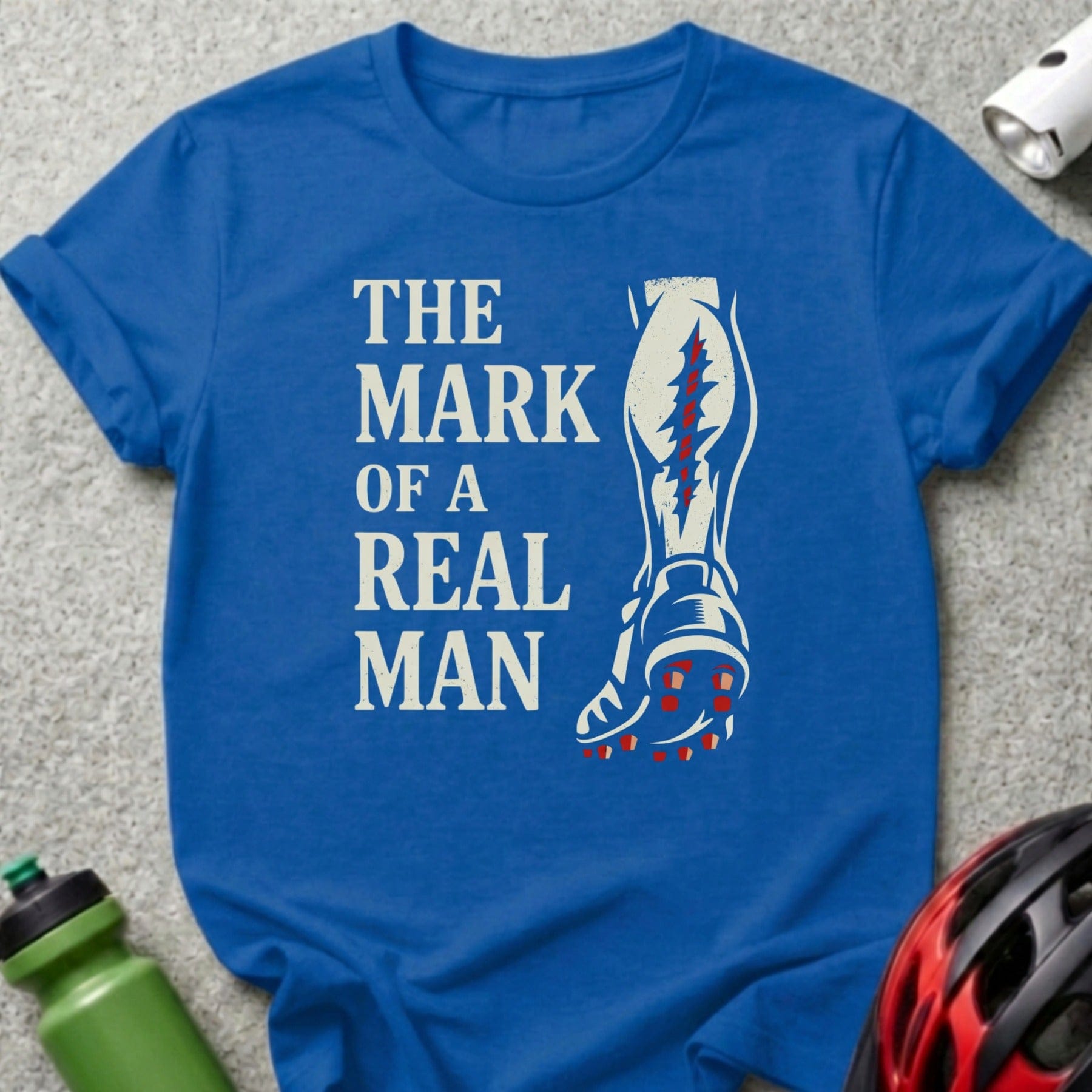 Blue t-shirt with "The Mark of a Real Man" and a leg graphic.