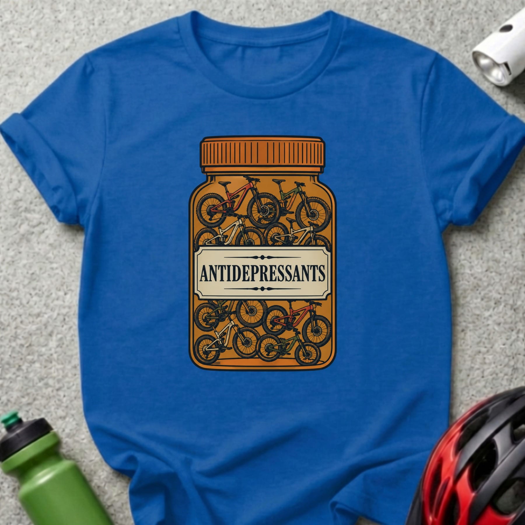 Blue t-shirt with bottle of bicycles labeled "ANTIDEPRESSANTS".