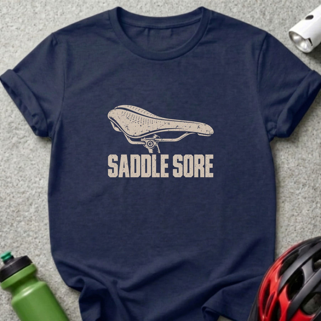 Navy blue t-shirt featuring a distressed white graphic of a bicycle saddle and the text SADDLE SORE.